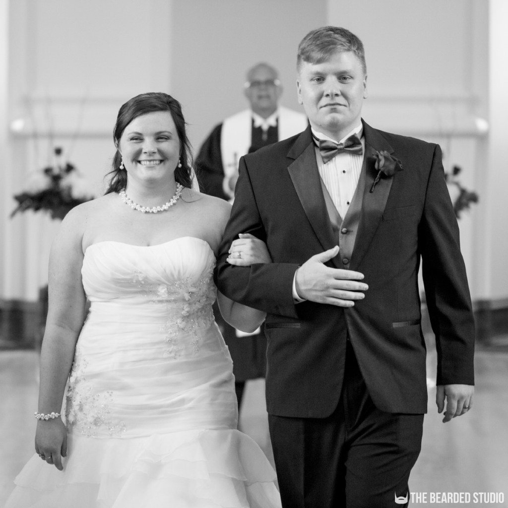 Bride And Groom Walking Down Aisle